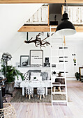 Loft extension with industrial pendant reclaimed panelling vintage ladder and sofa bed in Colchester home Essex UK