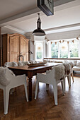 Sheepskin throws on dining table with original parquet floor Woodbridge Suffolk UK