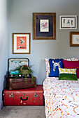 Vintage suitcases stacked by the bed in this children?s bedroom make a fun feature and provide great storage
