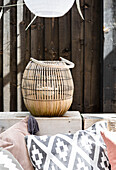 Bamboo lantern on bench in outdoor room, Cardiff, Wales, UK