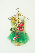 Green ballet dress on a hanger with christmas decorations for an alternative tree idea