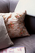 Detail of floral cushions on a chesterfield sofa