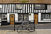 Mountain bike on pavement outside timber framed Hastings home
