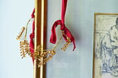Gold floral decoration on red ribbons in Massachusetts home, New England, USA