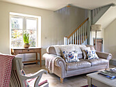 Leather sofa in open plan living room of Gloucestershire farmhouse, England, UK