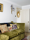 Green corduroy sofa in living room city of Bath Somerset, England, UK
