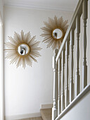 Sunburst convex mirrors in staircase of city of Bath home Somerset, England, UK