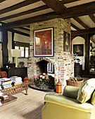 Brick fireplace in open plan drawing room timber framed country house Suffolk, England, UK