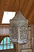 Metal lantern hangs from wooden ceiling of Shropshire chapel conversion England, UK