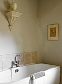 Antique wallbrace with urn above bath in Gloucestershire home, England, UK