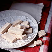 Plate of highland shortbread biscuits on a red and white tablecloth