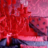 Detail of a red chandelier in a red and black room