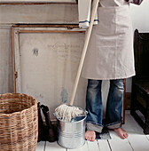 Woman standing with a mop and bucket ready to clean the floor