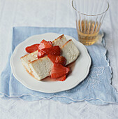 Baked cheesecake dessert with fresh strawberry topping on a tabletop setting