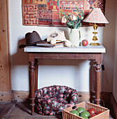 Hall table in period home with telephone and dog bed