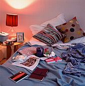 Teenage bedroom full of opened Christmas presents displayed on the bed