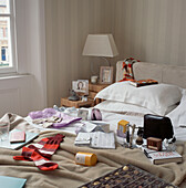 Adults bedroom full of opened Christmas presents displayed on the bed