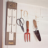 Wall with hanging trowel fork clippers and weekly planner