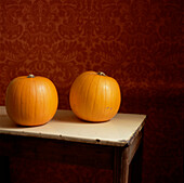Two pumpkins on a tabletop