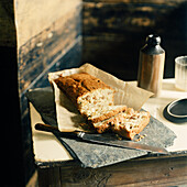 Home baked sliced loaf cake on a slab of slate