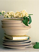 A stack of tableware with a sprig of flowers