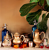 Shelf displaying a collection of metallic home wares