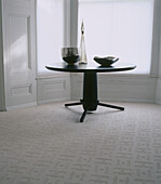 Neutral coloured carpeted dining room with dining table