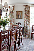 Polished wooden dining table and chairs in Wiltshire country house England UK