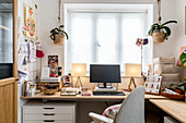 Computer on ply desk with matching lamps in studio of Devon cottage