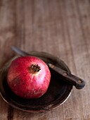 Pomegranate with knife on plate Southend-on-sea Essex England UK