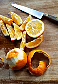 Peeled oranges with kitchen knife in Southend-on-sea, Essex, England, UK