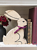 Rabbit book-end with hardbacked books on shelf Battersea London UK