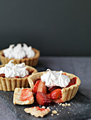 Rhubarb meringue tarts on a grey background