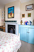 Light blue sideboard and artwork with tins on mantlepiece in Reading home Berkshire England UK