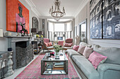 Tintenfarben und Kunstwerk mit silberner Feuerleiter und Tisch im Wohnzimmer einer viktorianischen Terrasse Wandsworth London Uk