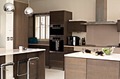 Kitchen with dark wood fitted units and lettering