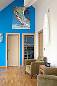 Artwork on bright blue feature wall of Isle of White holiday home