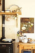 Utensil holder and range oven in kitchen of Wiltshire country home, England, UK