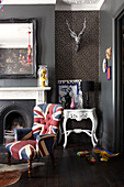 Union Jack armchair at fireside in retro-styled London living room, England, UK