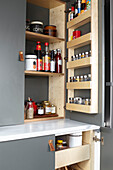 Bespoke larder fitted inside cupboards in industrial-style kitchen renovation London UK