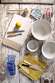 Geschirr und Servietten mit Zitrone auf Schneidebrett