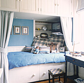 Boy's bedroom with custom built fitted storage cupboards