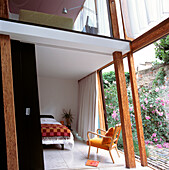 Mezzanine floor above the bedroom with views through sloping picture window in an open plan architect designed conversion