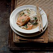 Thai coconut noodle soup with salmon and bean sprouts