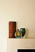 Colourful retro glass vases on a mantlepiece