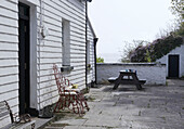 Courtyard outside Duncannon lighthouse with bench and horseshoe chair