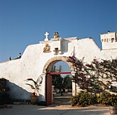 Open gate in wall surrounding patio