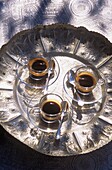 Cups of espresso coffee on ornate silver tray