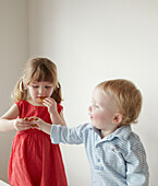 Brother and sister eating gingerbread men