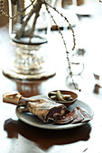 Dried meat and gherkins on table in Zermatt home, Switzerland